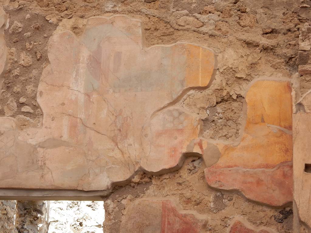 I.6.15 Pompeii. June 2019. Room 9, east wall of small garden. Detail of painting of scene with figures and temple.
Photo courtesy of Buzz Ferebee.

