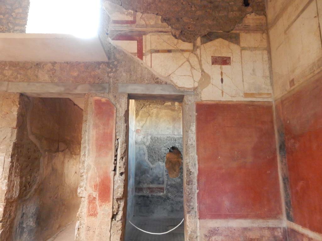 I.6.15 Pompeii. June 2019. Room 4, north-east corner of atrium, with doorway to corridor 7, on left.
The doorway to room 12 is centre right. Photo courtesy of Buzz Ferebee.

