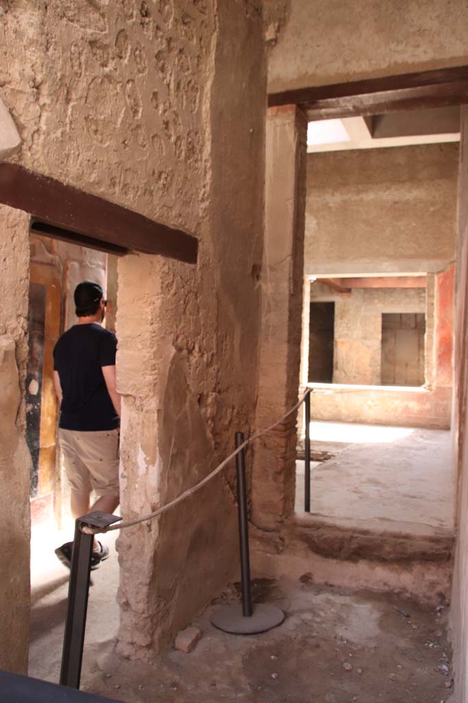 I.7.3 Pompeii. September 2019. Looking south from entrance I.7.2.
On the left is the doorway connecting to the entrance corridor of I.7.3.
On the right, looking south through site of staircase, through a room that would have been under the stairs, into atrium of I.7.3.

