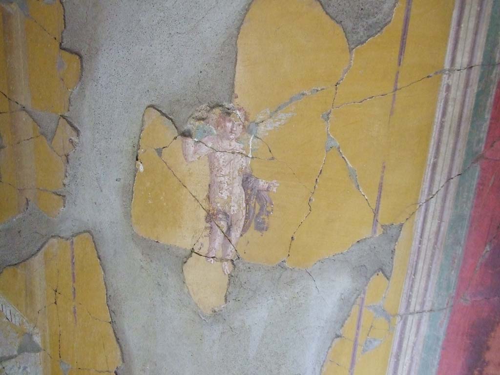 I.7.7 Pompeii. December 2006. Detail of wall painting of cupid, from east end of south wall of cubiculum.