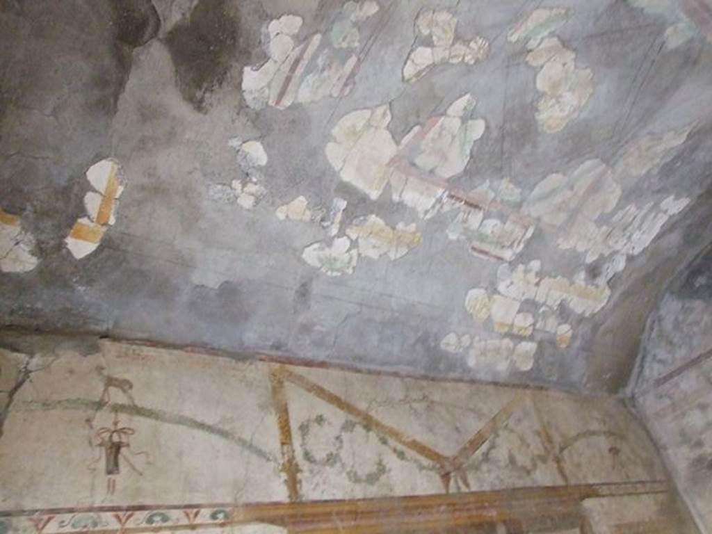 I.7.11 Pompeii. December 2006. Looking towards south-west corner. Detail of painted upper south wall and ceiling in bedroom on west side of atrium.
