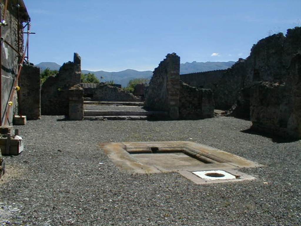 I.8.2 Pompeii. May 2004. Looking south across atrium to tablinum with peristyle beyond. According to Jashemski, two steps led up to the tablinum from the atrium.  At the rear of the tablinum was the peristyle, which was enclosed by a portico on four sides.  None of the columns are standing today, and part of the floor on the north, east and west portico was also destroyed by bombing in 1943.  A gutter at the edge of the garden collected rain water which was stored in the large cistern under the peristyle. The water appeared to have been used in the adjacent dye-shop (I.8.19) at the rear. See Jashemski, W. F., 1993. The Gardens of Pompeii, Volume II: Appendices. New York: Caratzas. (p.42)
