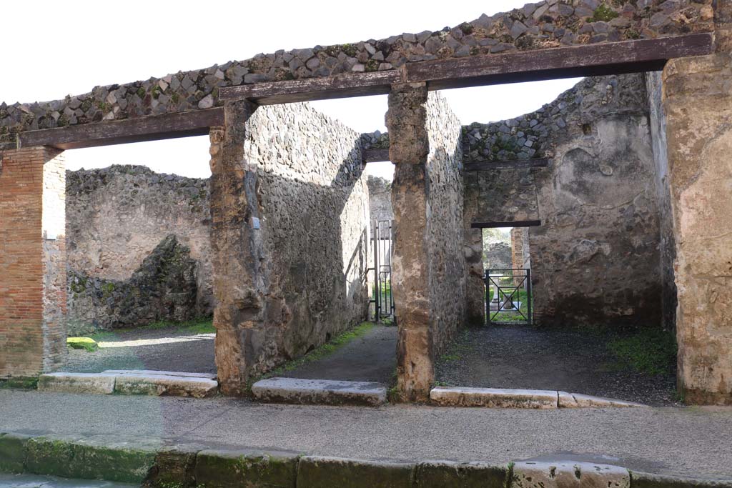 I.8.6, on left, I.8.5, centre, and I.8.4, on right, Pompeii. December 2018. 
Looking south to entrances on Via dell’Abbondanza. Photo courtesy of Aude Durand.
