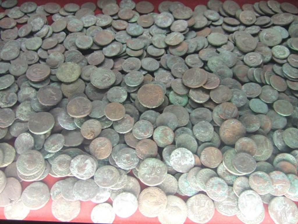 I.8.8 Pompeii. Large hoard of 1385 bronze coins. Found in the central container of the eastern arm of the counter. Now in Naples Archaeological Museum.
