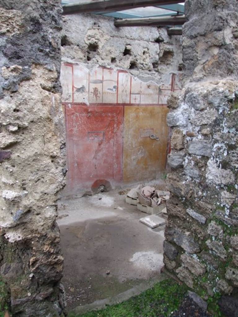 I.8.14 Pompeii. December 2007. Room 10, room in north-east corner. The walls were painted in the IVth style, in the middle zone with simple yellow and red panels with still-life paintings. In the upper zone, painted white and divided into areas, were panels and paintings independent of the partitions of the area below.

