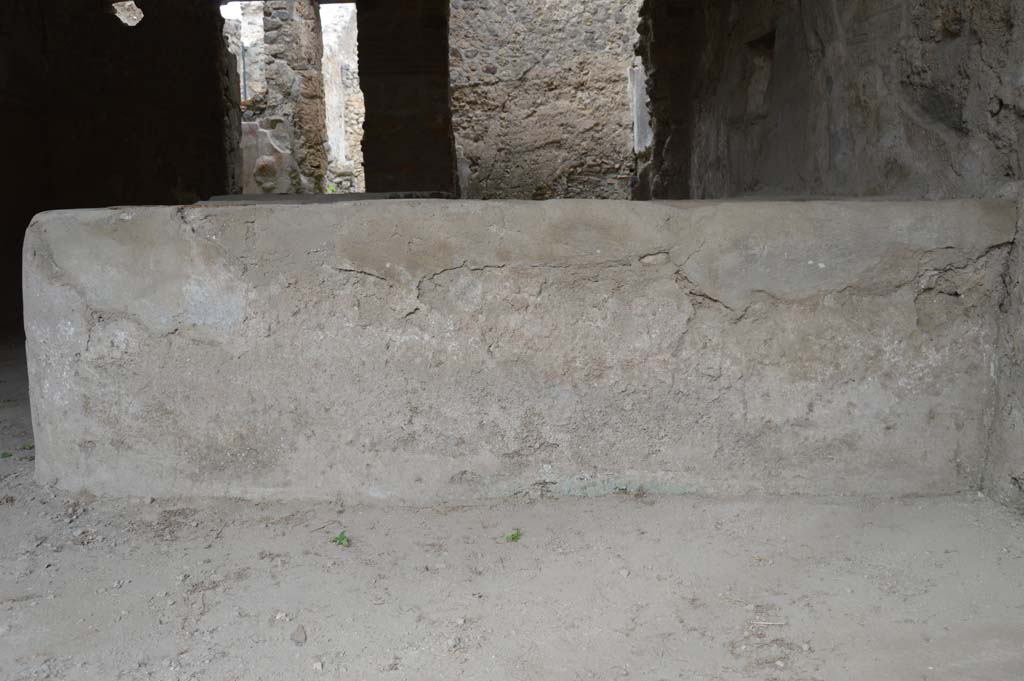 I.8.15 Pompeii. October 2017. Looking north to detail of front façade of podium in shop-room.
Foto Taylor Lauritsen, ERC Grant 681269 DÉCOR.
