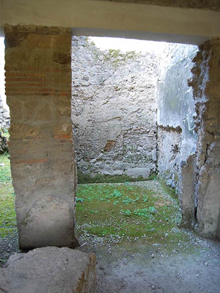 I.8.15 Pompeii. October 2013. Doorway on east side (on right side) of shop, possibly used as a cubiculum (see p.207 of Rivista). Photo courtesy of Paula Lock.
See Rivista di Studi Pompeiani, Vol III, 1989, article by Castiglione, V., Del Franco, M., and Vitale, R: “L’insula 8 della Regio I, un campione d’indagine socio-economica”, (p.185-221)
