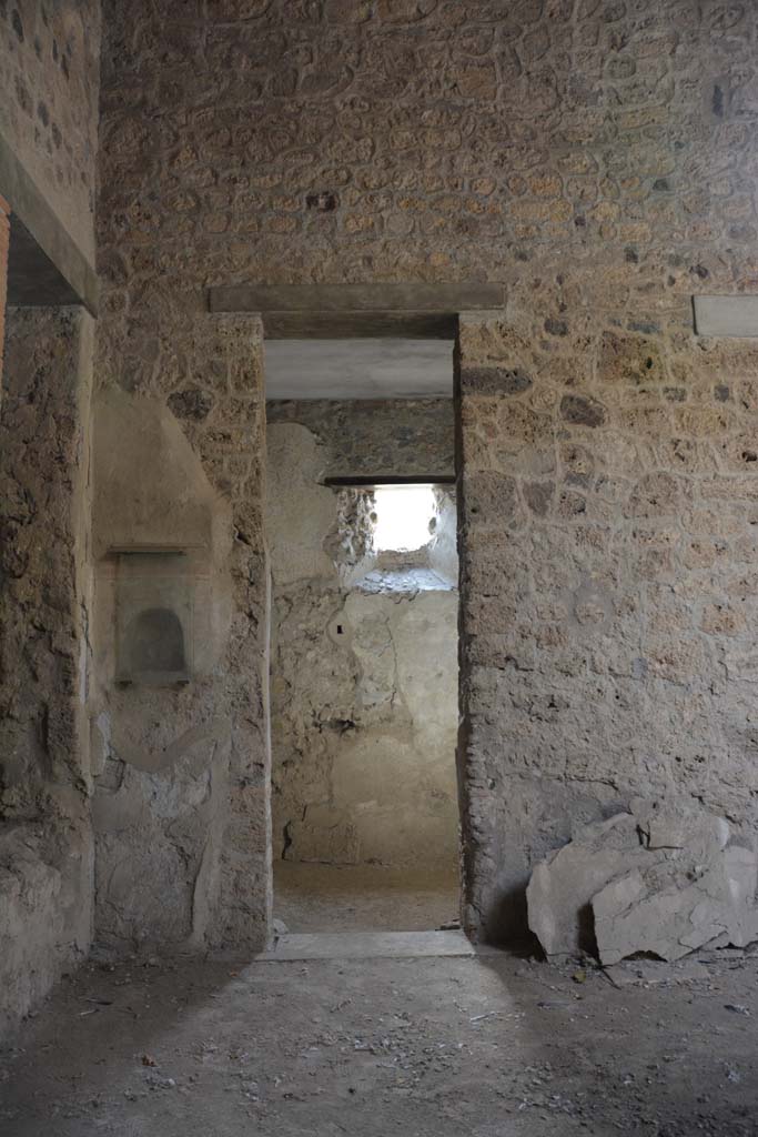 I.8.17 Pompeii. March 2019. 
Room 8, looking south to doorway in south-east corner of atrium, with niche shrine, on left.   
Foto Annette Haug, ERC Grant 681269 DÉCOR.
