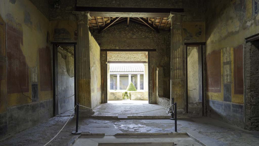 I.10.4 Pompeii. August 2021. 
Looking south across impluvium in atrium towards the tablinum, room 8. Photo courtesy of Robert Hanson.
