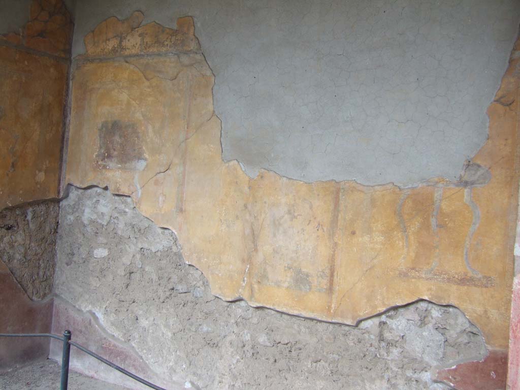 I.10.4 Pompeii. May 2006. Alcove 23, looking towards south-east corner, on left.
According to PPM 
In the middle zone of the east wall (on the left of above photo) would have been a painted panel with a sitting poet (perhaps Euripides?), with a painted carpet border around the edge of the panel.
See Carratelli, G. P., 1990-2003. Pompei: Pitture e Mosaici: Vol. II. Roma: Istituto della enciclopedia italiana, (p.366 and 367, no. 202).

