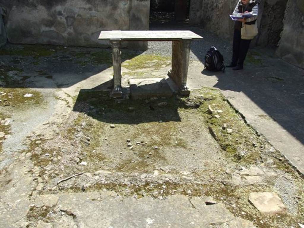 I.10.7 Pompeii. March 2009. Room 4, looking south across impluvium in atrium, with table.  