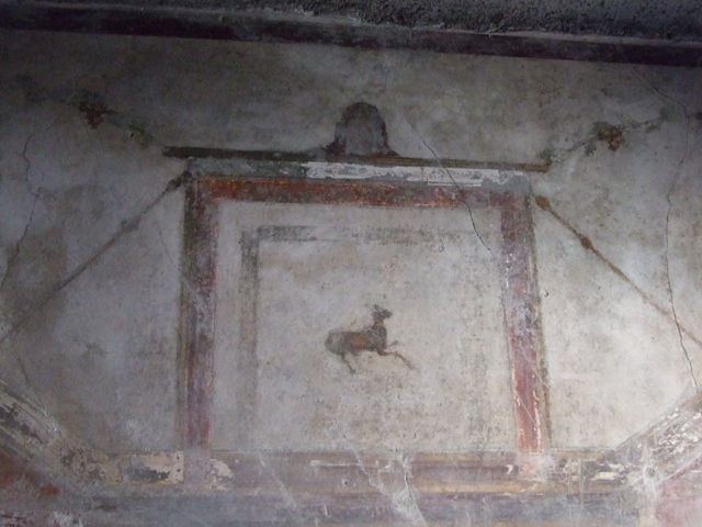 I.10.11 Pompeii.  March 2009.  Room 12.  Cubiculum.  West wall.  Centre above door.  Painting of a goat? and mask.