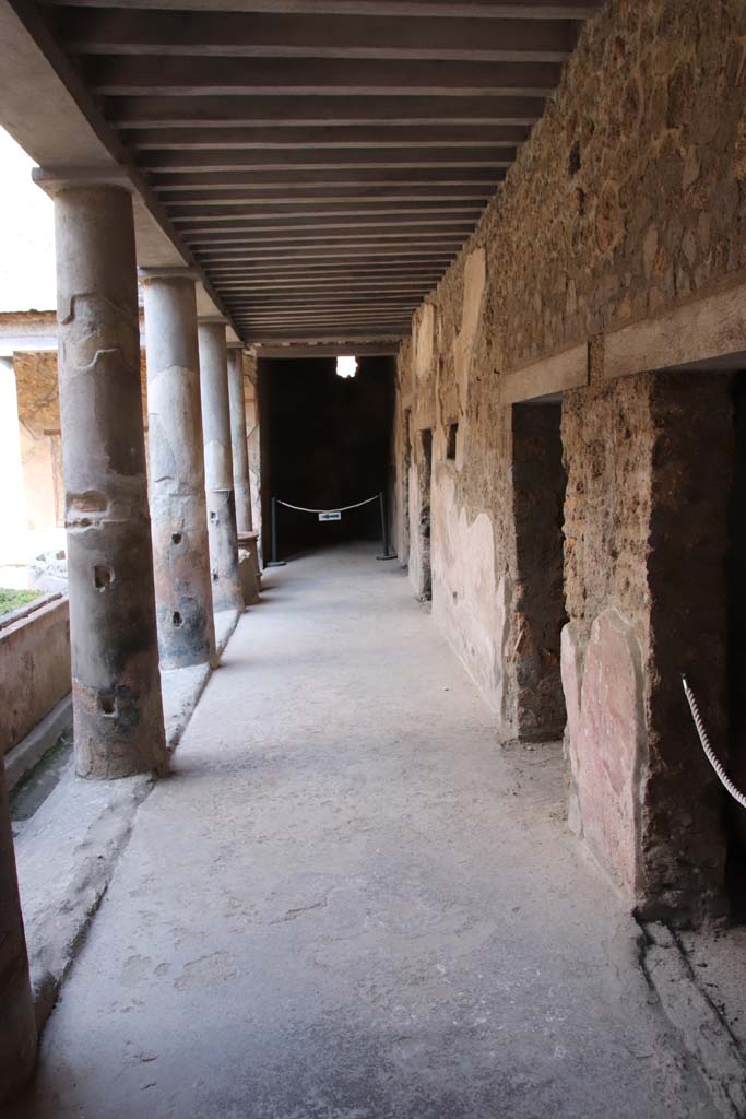 I.10.11 Pompeii. September 2021. 
Room 10, peristyle, looking south across west portico towards doorway to room 19, with doorways to atrium, on right. 
Photo courtesy of Klaus Heese.

