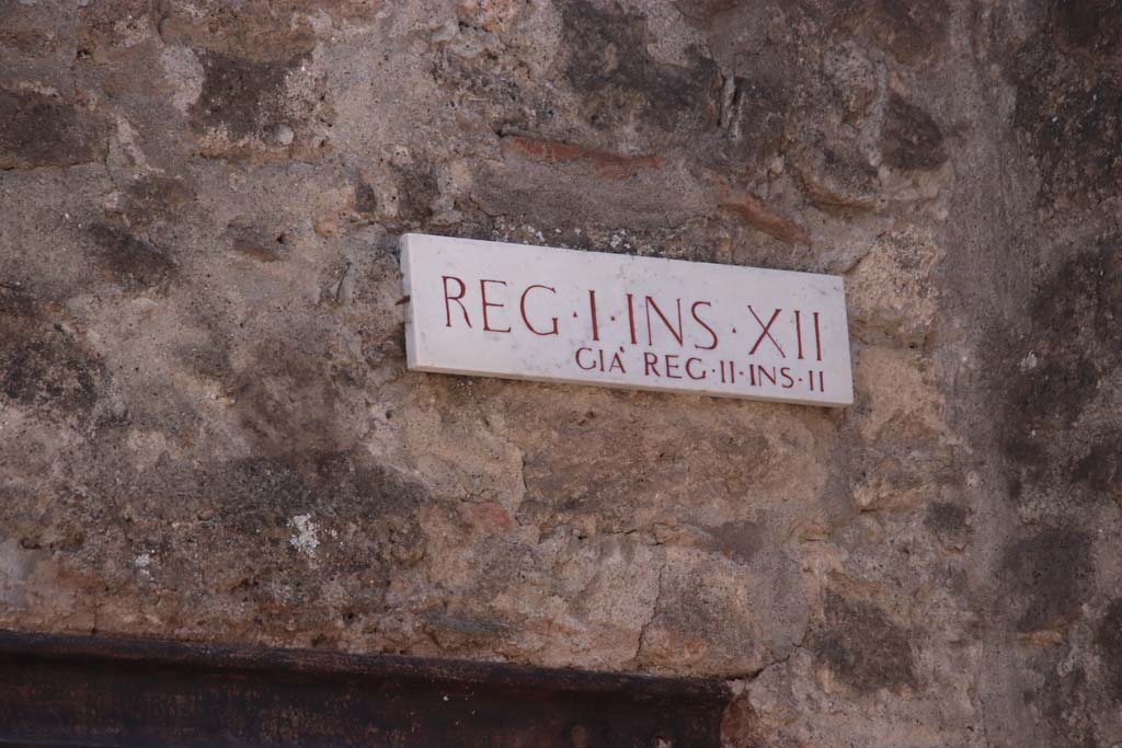 I.12.1 Pompeii. September 2019. 
Insula identification plaque, Reg. I. Ins. X11, previously known as Reg. II, Ins. 11 (which is Reg. II, Ins. 2). 
Photo courtesy of Klaus Heese.

