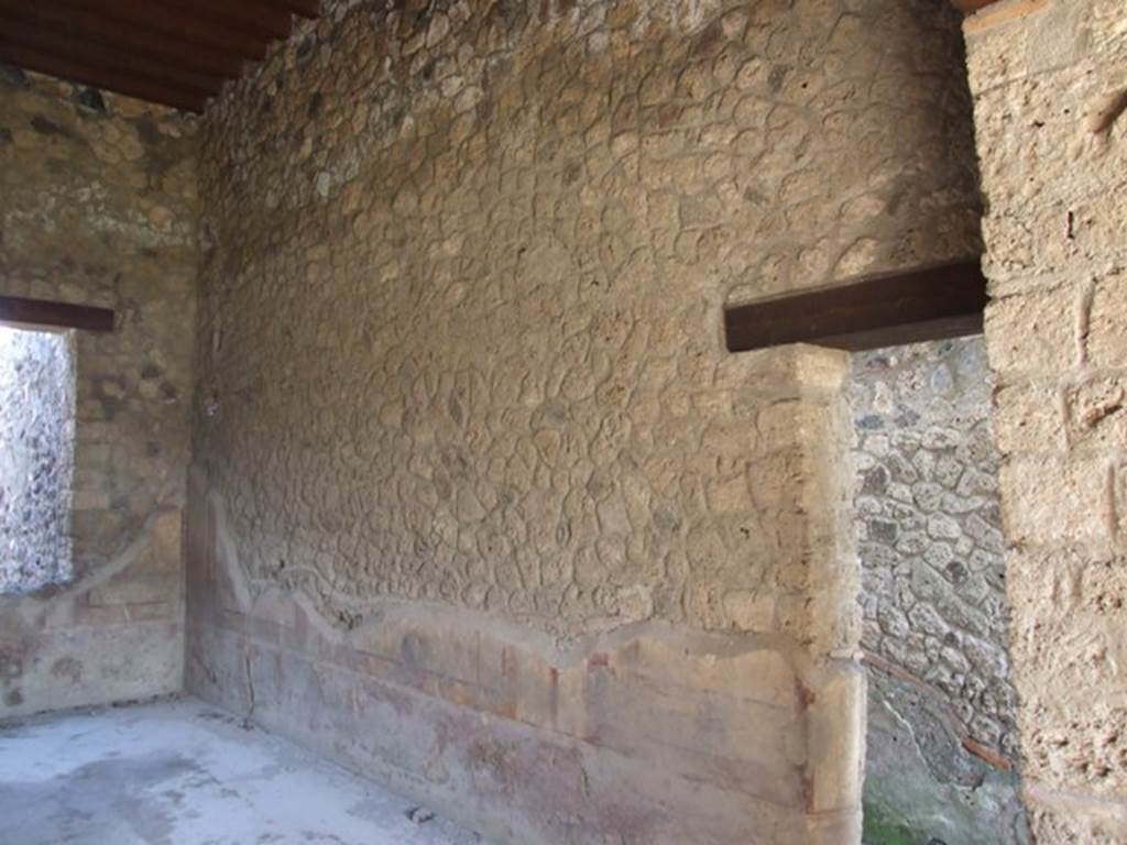 I.12.2 and I.12.1 Pompeii.  March 2009.  Room 7. Triclinium.  East wall with door to corridor room 6.