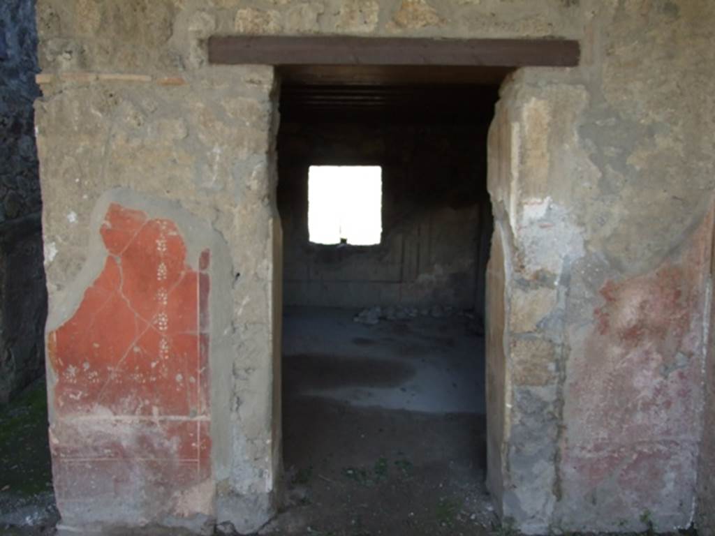I.12.2 and I.12.1 Pompeii.  March 2009.  Doorway to room 9, from portico.