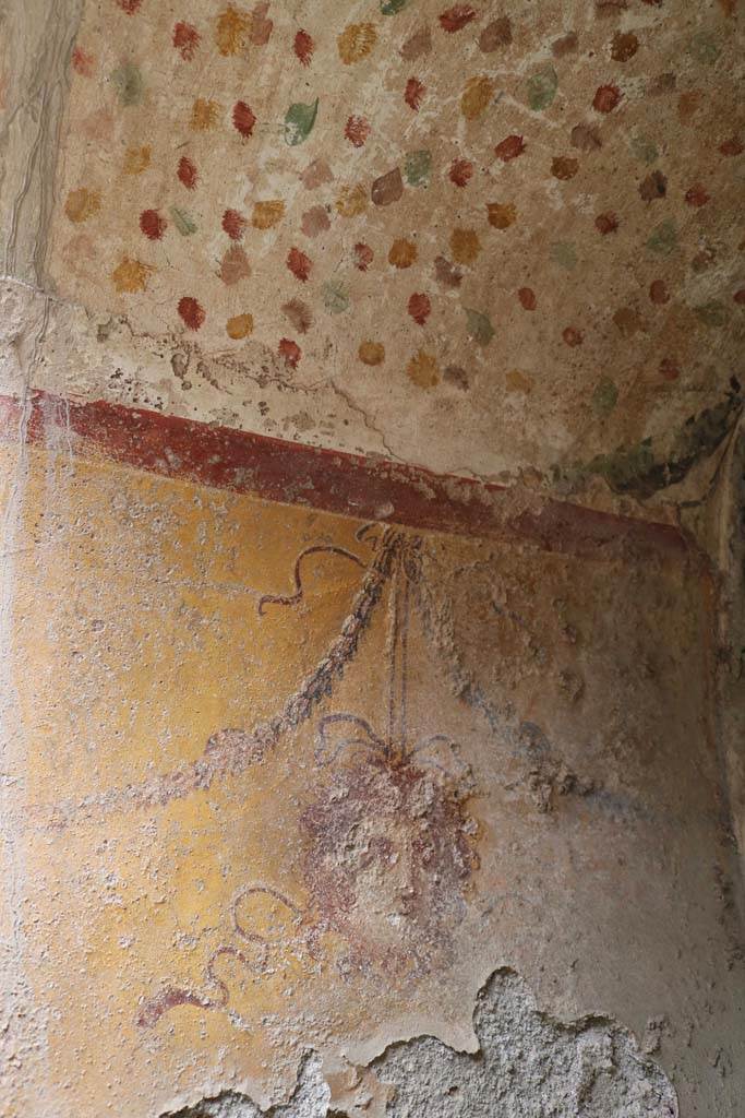 I.12.5 Pompeii. December 2018. 
North wall of painted Lararium, with mask hanging from a garland. Photo courtesy of Aude Durand.
