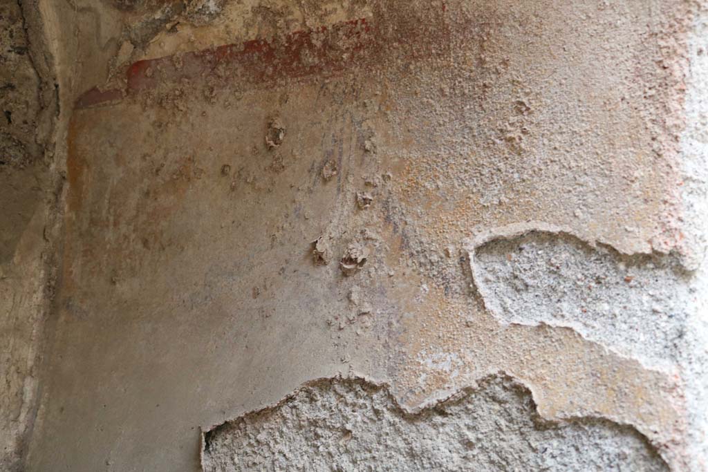 I.12.5 Pompeii. December 2018. Detail of lower painted decoration on south side of painted lararium. Photo courtesy of Aude Durand.

