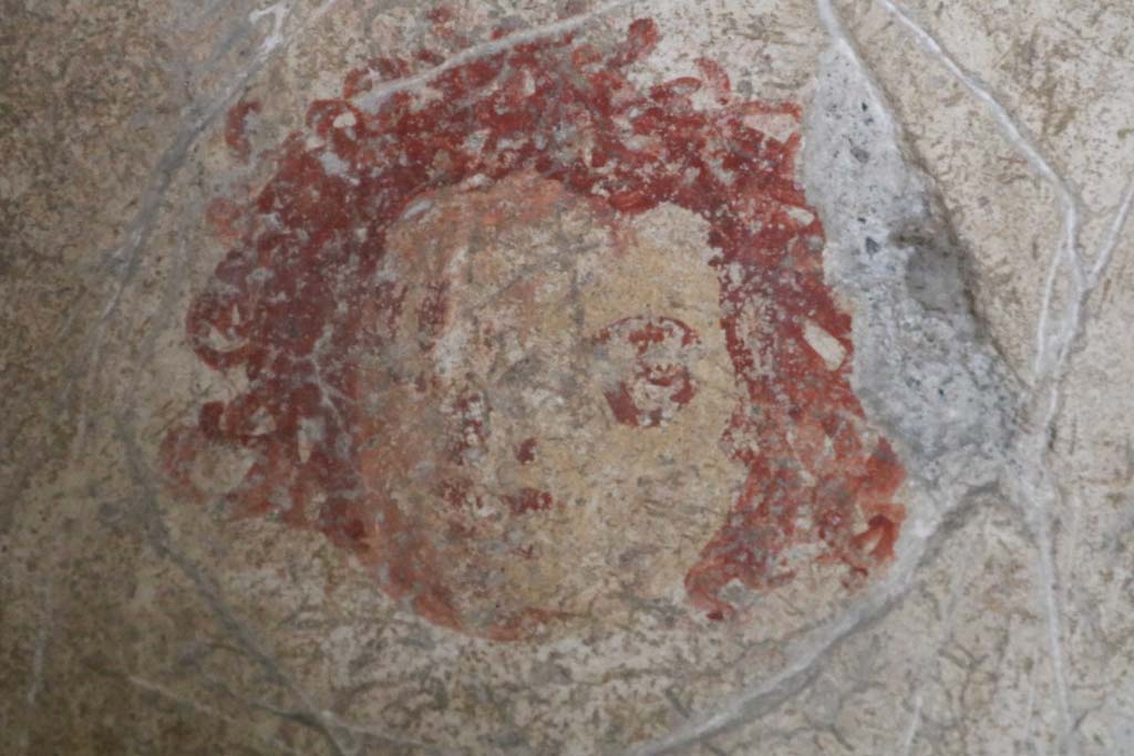 I.12.5 Pompeii. December 2018. Detail of painted mask on north wall of cubiculum. Photo courtesy of Aude Durand.