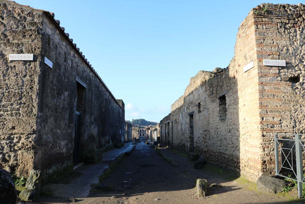 Via Castricio, Pompeii. December 2018. 
Looking west between I.15 and 1.12, from the junction with Vicolo dei Fuggiaschi, with I.12.8 on right. Photo courtesy of Aude Durand.

