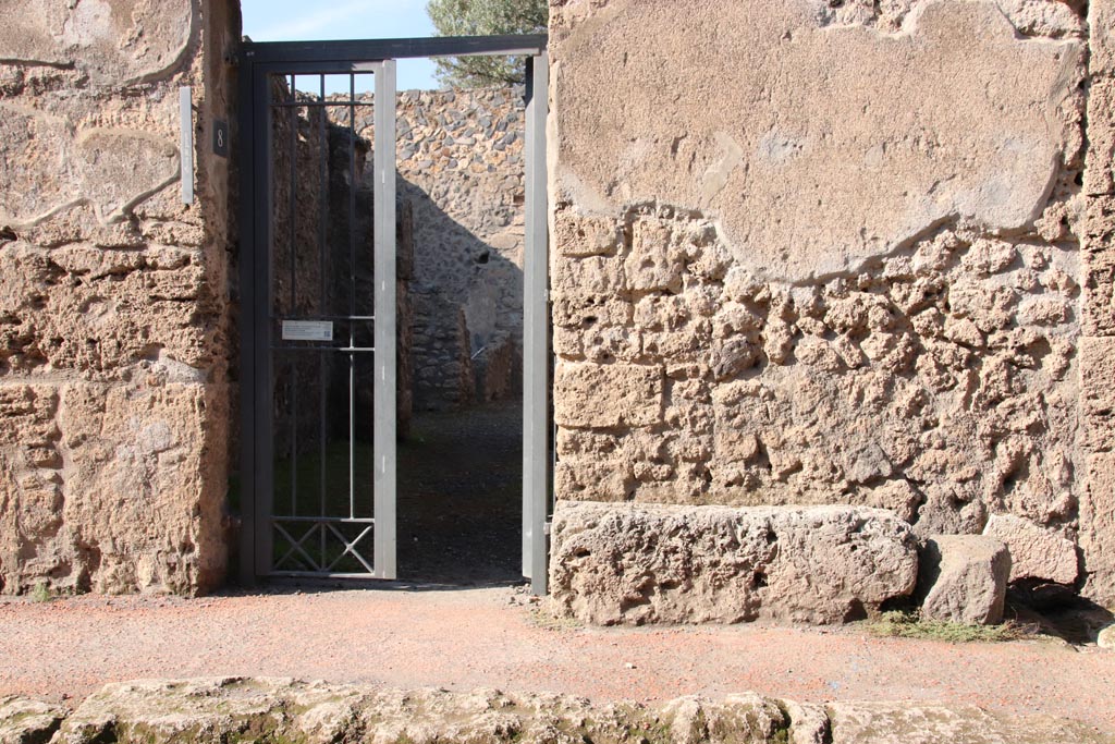 I.12.8 Pompeii. October 2022. 
Looking north towards entrance doorway, with bench/seat on east side. Photo courtesy of Klaus Heese.
