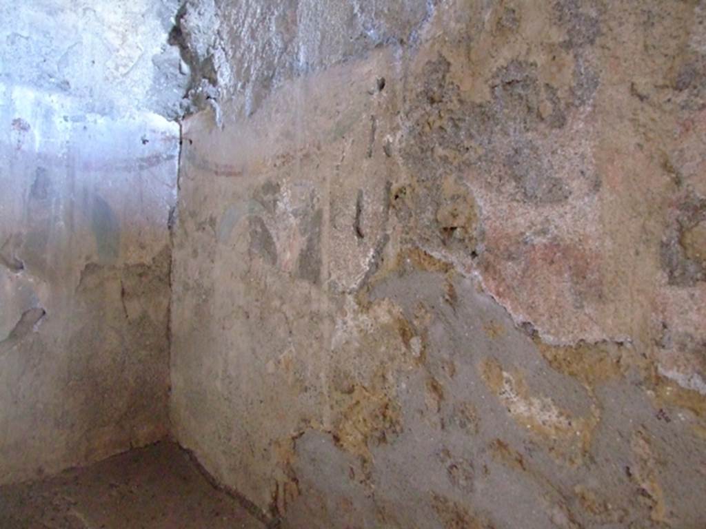 I.12.11 Pompeii. March 2009. 
Lararium painting in south-east corner and south wall in kitchen above hearth with traces of painted garlands. 
