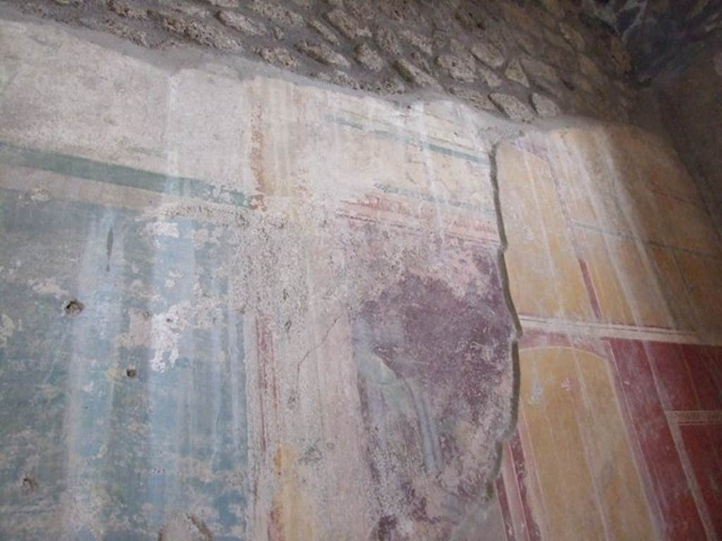 I.12.11 Pompeii. December 2007. Upper south wall at west end of triclinium, Style IV painted over earlier style II on south wall.
