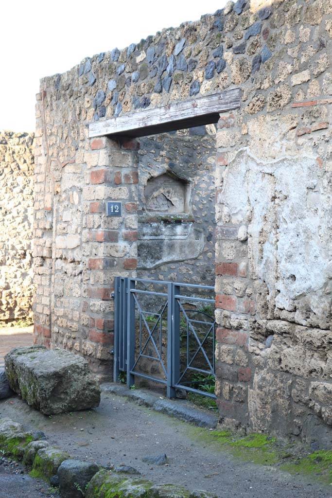 I.12.12 Pompeii. December 2018. 
Entrance doorway on north side of Via di Castricio. Photo courtesy of Aude Durand.
