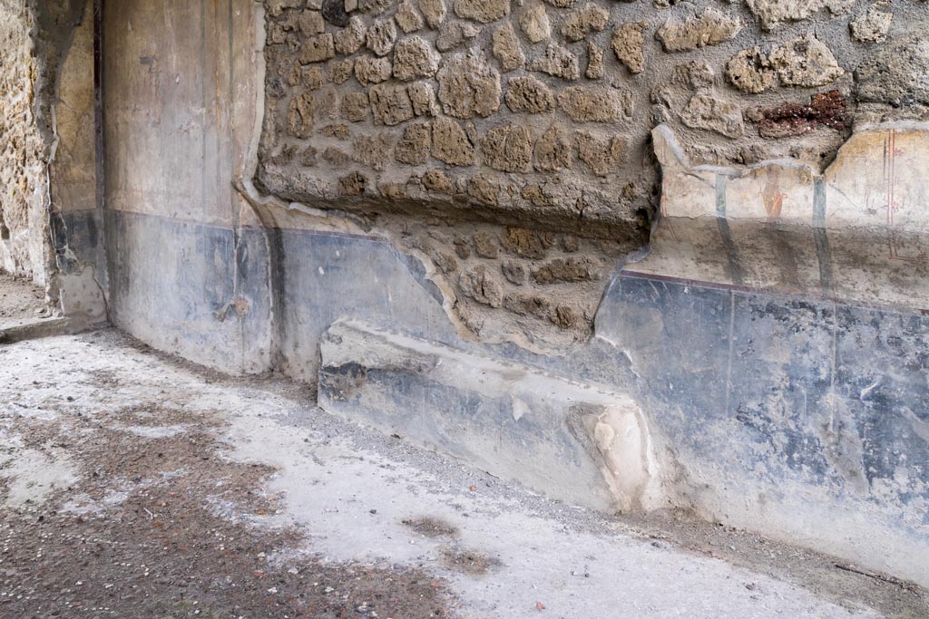 I.13.2 Pompeii. March 2023. Detail of lower west wall of triclinium, looking south. Photo courtesy of Johannes Eber.

