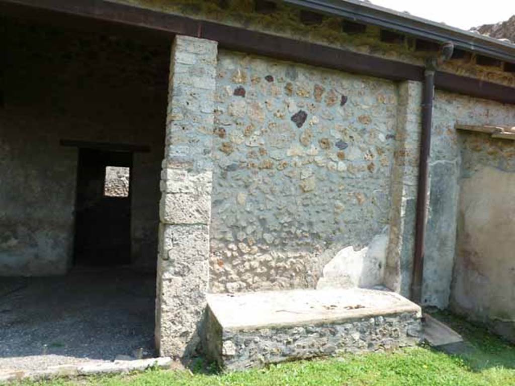 I.13.2 Pompeii. May 2010.  East wall of garden with a long masonry bench built between the 2 pilasters in the east wall and doorway to kitchen.
