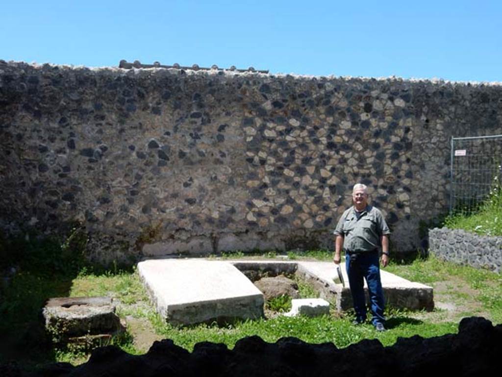 I.14.12, Pompeii. May 2018. Buzz being tempted by a sit down on the triclinium couches after all his hard work, only joking! Photo courtesy of Buzz Ferebee
