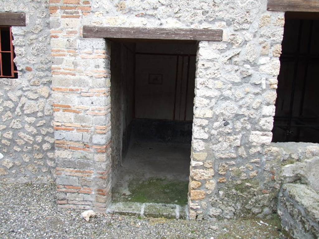 I.16.3 Pompeii. December 2006. Doorway to triclinium on east side of atrium, with window onto garden.