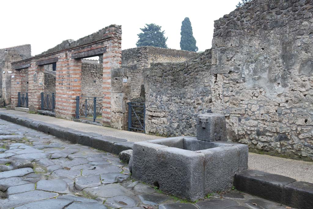 II.1.6, on left to II.1.3, in centre, Pompeii. December 2018 
Looking south-east on south side of Via dellAbbondanza, from fountain. Photo courtesy of Aude Durand.

