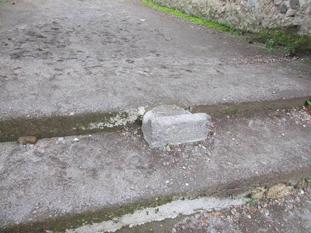 II.1.9 Pompeii.  December 2006. Base of portal between II.1.9 and II.9.6 in centre of steps to vicolo.  It was originally used for crowd control to Amphitheatre.   
