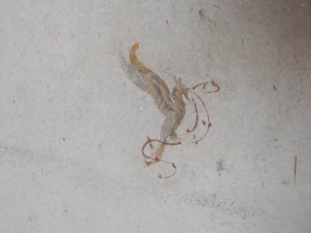 II.9.3, Pompeii. May 2018. Room 11, detail of painted winged creature from east wall in north-east corner.  Photo courtesy of Buzz Ferebee. 

