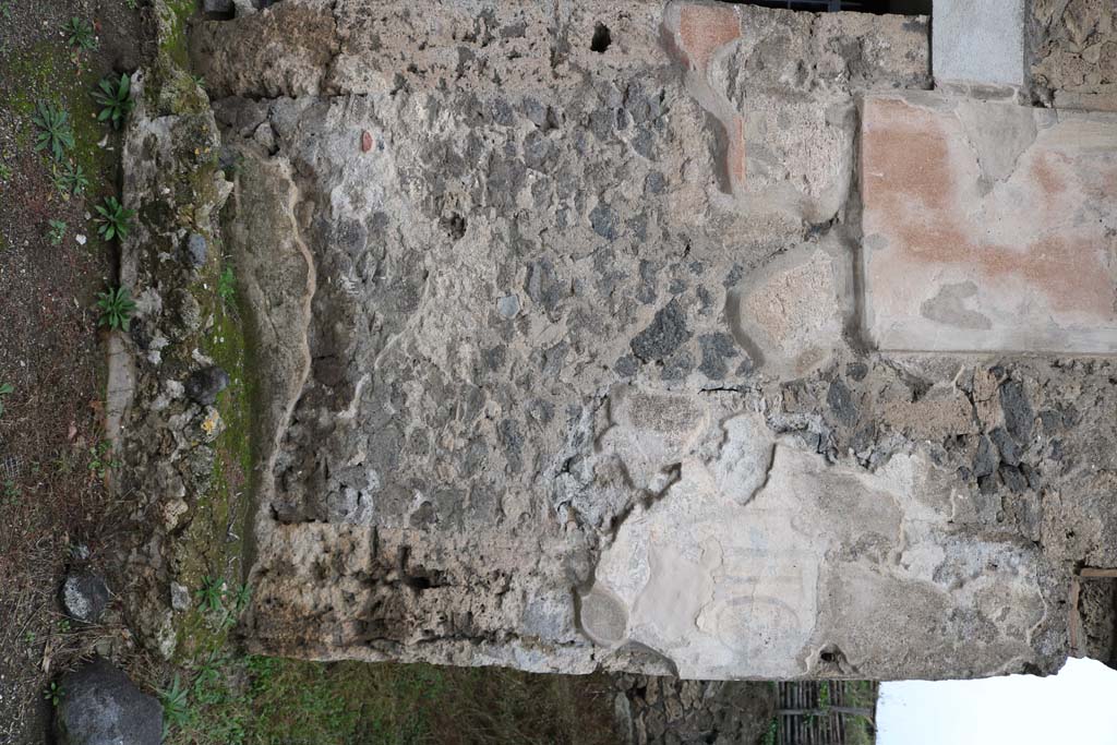 III.6.1 and III.6.2 Pompeii. December 2018. 
Detail of remaining painted inscription on front façade between two entrances. Photo courtesy of Aude Durand.

