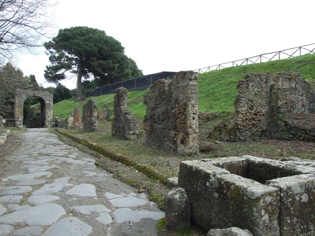 III.11.a Pompeii. May 2006. Remains of entrance, by poppies in blocked side street