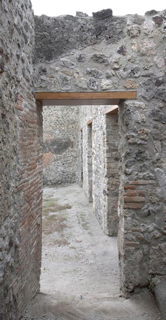 V.1.3 Pompeii. c.2012.
Room “b”, south wall of corridor, with doorway into atrium. Photo by Hans Thorwid.
“S wall in 2012. Restored parts of the wall photographed and merge with the lower part and floor line of earlier photos from 2005-7.”
Photo and words courtesy of the Swedish Pompeii Project. 
