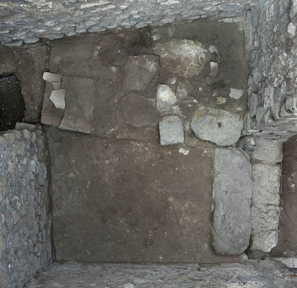 V.1.3 Pompeii. c.2008-10. 
Room “c”, flooring of outer room with doorway into latrine, on left, and into corridor “b”, on right.  
Photo by Hans Thorwid.
Photo courtesy of the Swedish Pompeii Project. 
