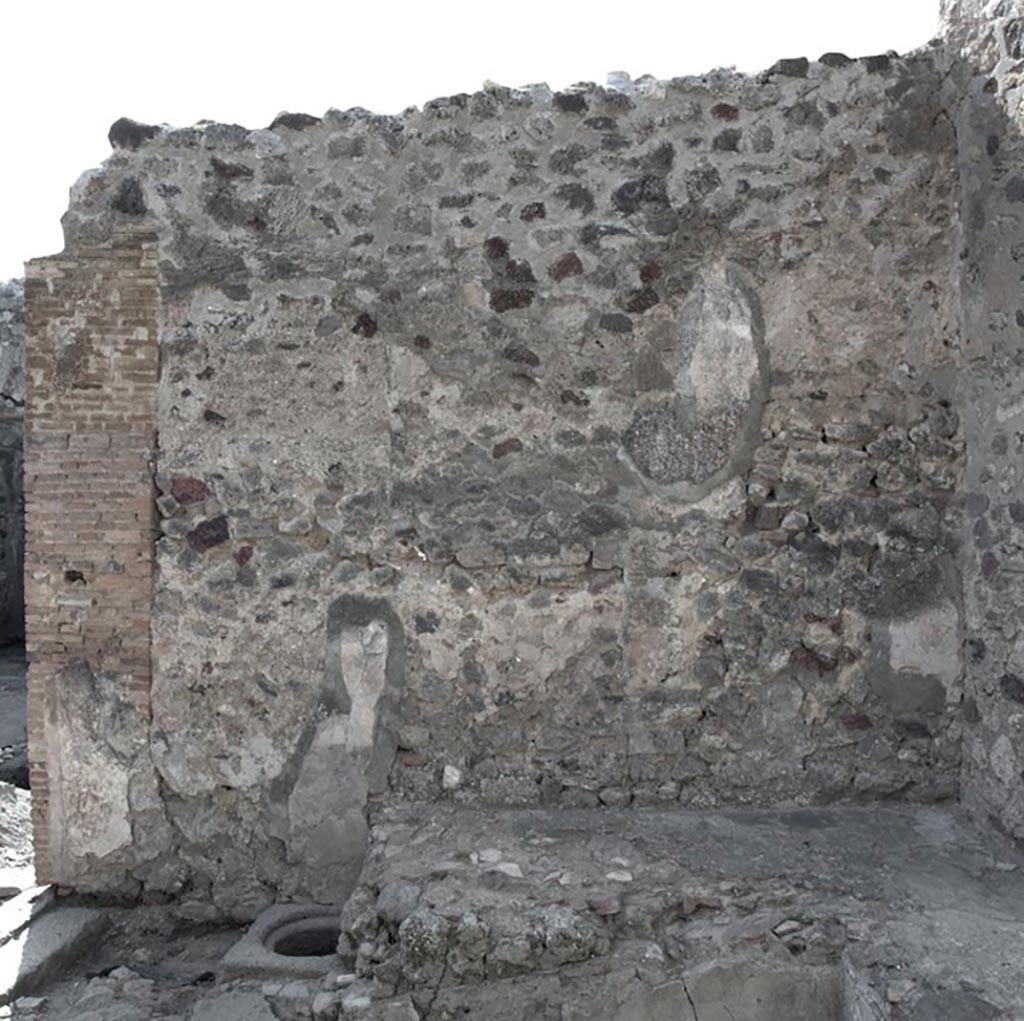 V.1.3 Pompeii. c.2012.
Room “d”, west wall, with cistern mouth and bench. Photo by Hans Thorwid.
“W wall in 2012. Restored parts of the wall photographed and merge with the lower part and floor line of earlier photos from 2005-7.”
Photo and words courtesy of the Swedish Pompeii Project. 

