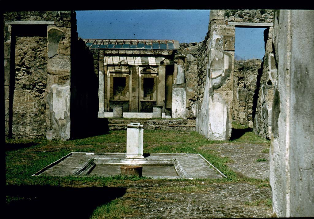 V.1.7 Pompeii. 1920s-1930s postcard. Looking north across impluvium in atrium with model of bronze bull, in situ. 
Photo courtesy of Rick Bauer.
