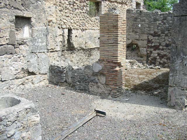 V.I.13 Pompeii. December 2006. Looking east through doorway into rear room of thermopolium.  