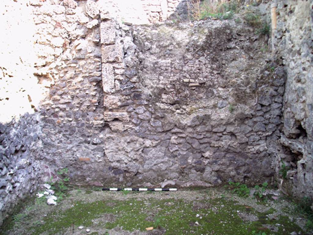 V.1.15 Pompeii. September 2009. Room in bakery on west side of oven showing east wall and the side of the large oven. Photo courtesy of Jared Benton.
