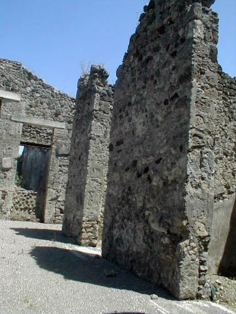 V.1.26 Pompeii. May 2005. Rooms on south side of atrium, showing tall doorways. Taken from V.1.27.
