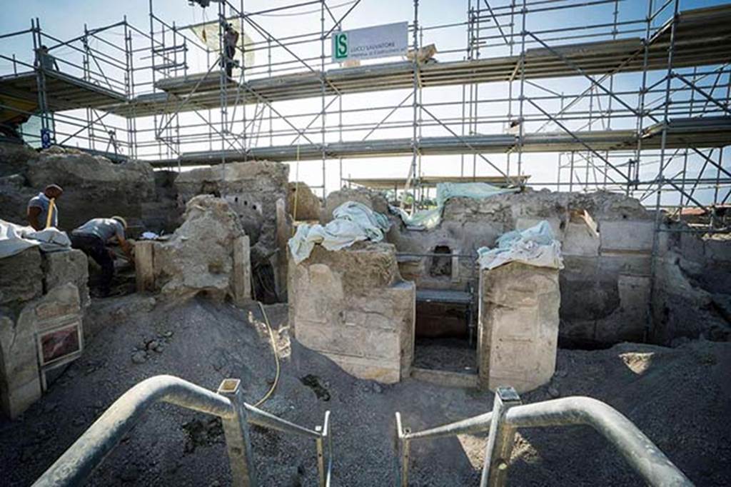 V.2.15 Pompeii. August 2018. The two excavators are working in room A3, which is on the east side (left).
On the south side of atrium A12 are rooms A17, A11 in the centre and room A13 on the right.
Photograph © Parco Archeologico di Pompei.
