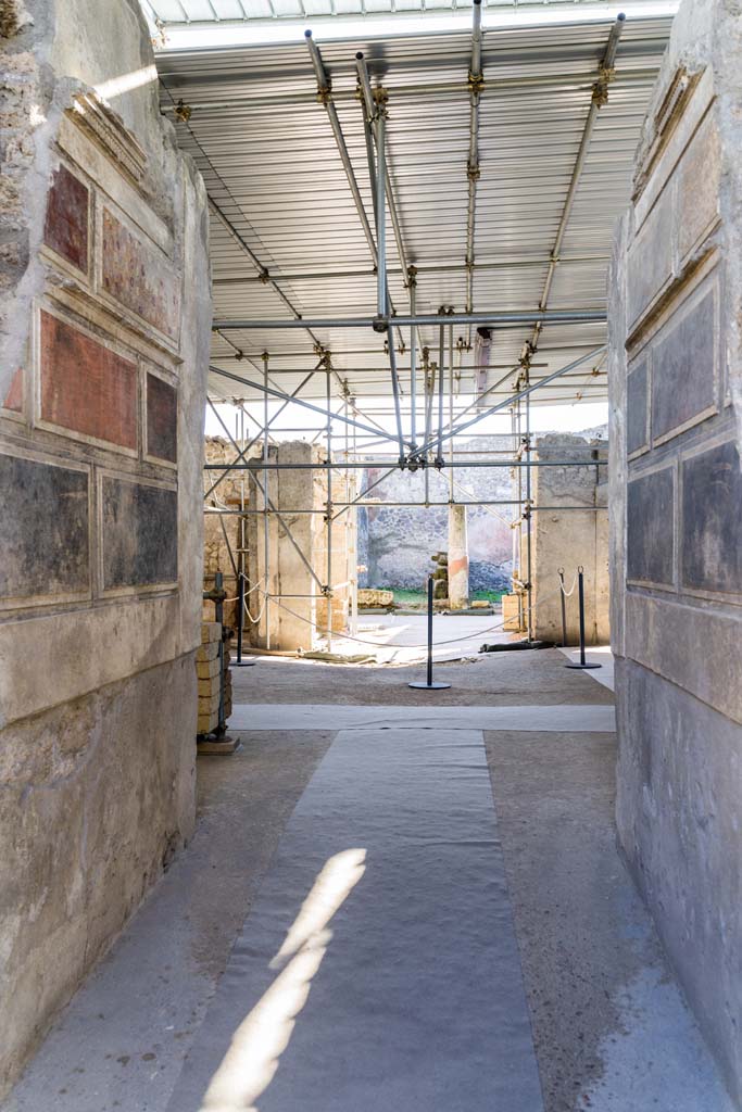 V.2 Pompeii. Casa di Orione. April 2022. 
Looking west from entrance corridor/fauces towards atrium and across towards peristyle.
Photo courtesy of Johannes Eber.
