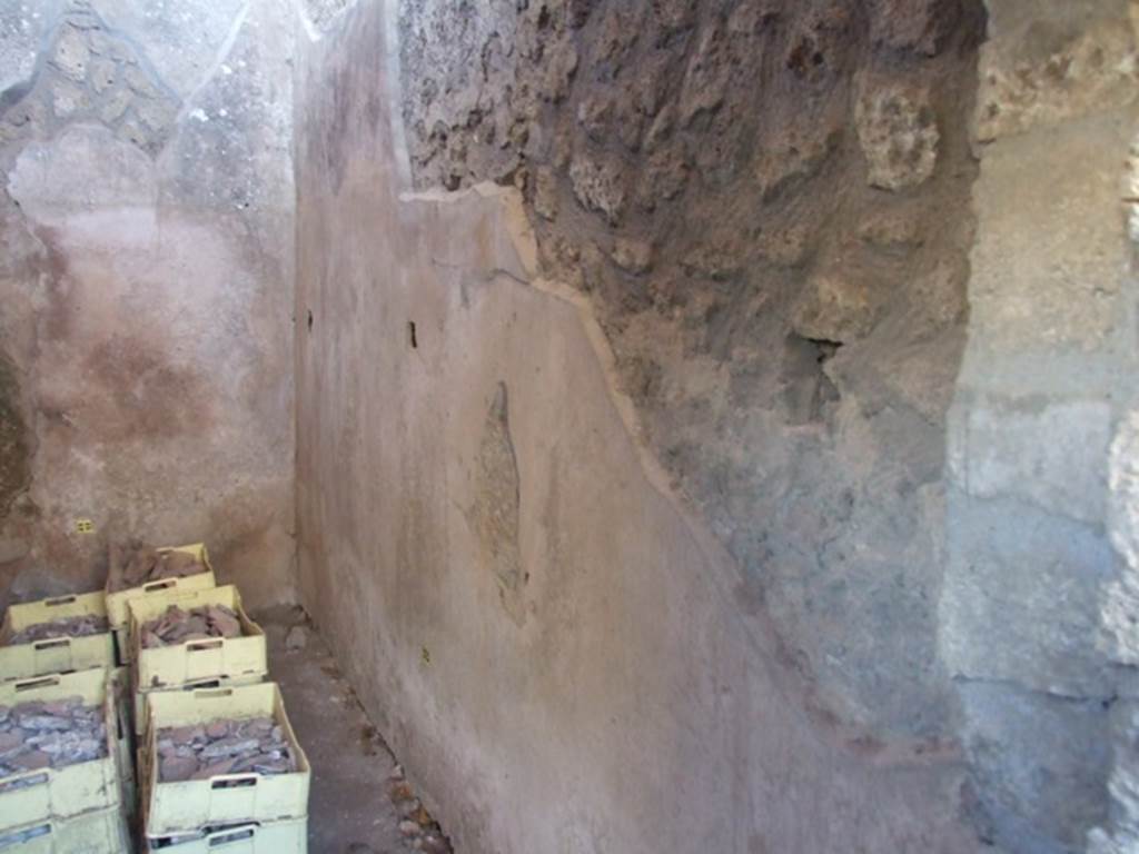 V.3.4 Pompeii. March 2009.  Small room, West wall with remains of shelving supports.