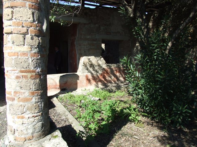 V.3.4 Pompeii. March 2009. Room on west side of portico, with small joining door to another room.
