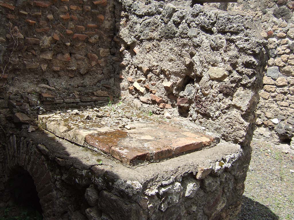 V.4.7 Pompeii. May 2006. Stone bench or hearth with terracotta tiles on the top.