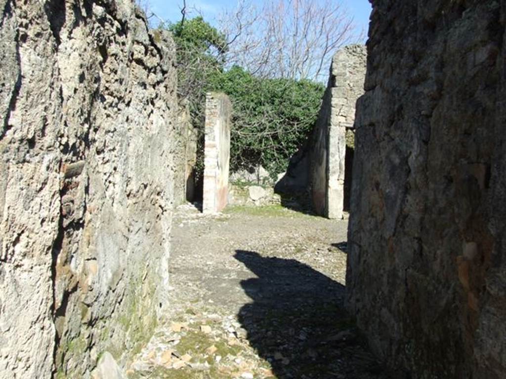 V.4.c Pompeii. March 2009. Looking east across room A, the fauces, towards atrium and tablinum.
According to NdS, (1902) –
In the house in Reg. V that had its doorway opposite to the one at V.3.11 (therefore V.4.c), I verify that on the 1st May, an important discovery was made of 4 skeletons with the following objects –
Large gold bracelet in the shape of facing serpents;
Two gold rings set with stone;
A pair of earrings;
One aureus of Nero, and two of Domitian;
29 silver coins, silver bronze mirror

The death of the unfortunates would have seemed to have been from the fire that caused the floor of the upper room, where they had taken refuge, to collapse, and whose violence had partly burnt their bones and left traces on the paintings on the walls.

The house, to judge from the part excavated up until now, will not have been very large, nor as beautiful as the one opposite to it (V.3.11). 
However, it had in the tablinum fairly good paintings showing the four seasons (Autumn completely disappeared, and in the atrium was a painting of Mercury with purse and staff/caduceus, very similar to the one existing in the thermopolium V.4.6-7 (see Notizie1899, p. 343) however, “ours” had a large serpent curled/tangled at his feet.
R.PARIBENI.
See Notizie degli Scavi, 1902, (p.276).
